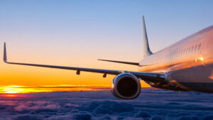 Close-up of passenger airplane flying in the dawn sky