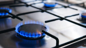 Gas kitchen stove cook with blue flames burning