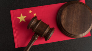 Judge gavel on the China flag. Law and legality in PRC. Violation of human rights