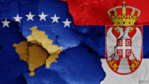 flags of Kosovo and Serbia painted on cracked wall